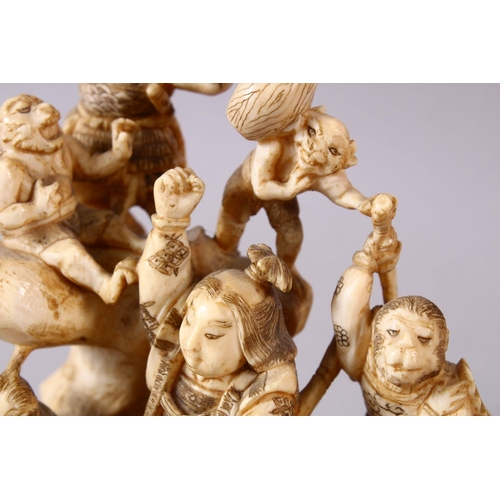 35 - A JAPANESE MEIJI PERIOD CARVED IVORY OKIMONO GROUP - depicting figures attacking oni demons, one dog... 