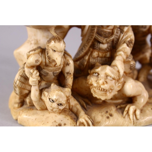 35 - A JAPANESE MEIJI PERIOD CARVED IVORY OKIMONO GROUP - depicting figures attacking oni demons, one dog... 