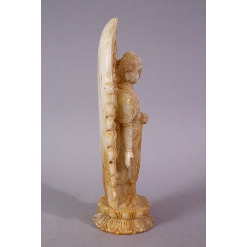 40 - A 19TH / 20TH CENTURY CHINESE CARVED WHITE JADE / SOAPSTONE FIGURE OF A DEITY / BUDDHA, stood upon a... 