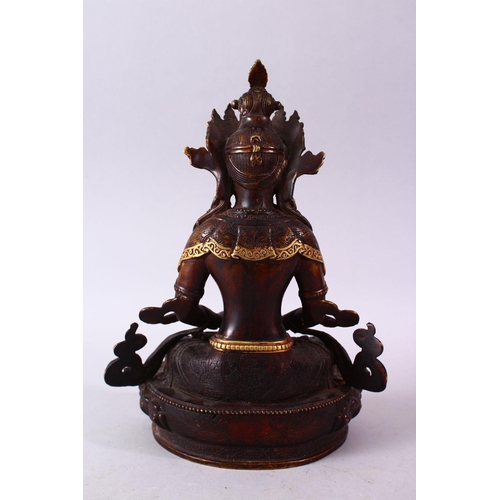 49 - A CHINESE GILT BRONZE INLAID FIGURE OF A DEITY / BUDDHA, in a seated position with an object in hand... 