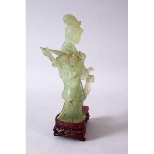 50 - A 19TH / 20TH CENTURY CHINESE CARVED JADE FIGURE OF GUANYIN, upon a carved wooden base, 16cm x 11cm