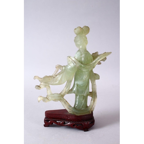 50 - A 19TH / 20TH CENTURY CHINESE CARVED JADE FIGURE OF GUANYIN, upon a carved wooden base, 16cm x 11cm