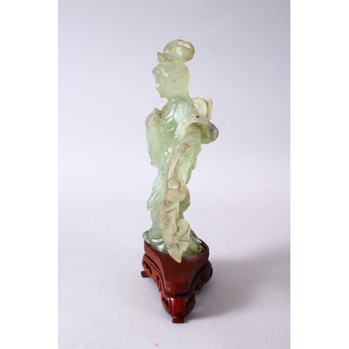 50 - A 19TH / 20TH CENTURY CHINESE CARVED JADE FIGURE OF GUANYIN, upon a carved wooden base, 16cm x 11cm