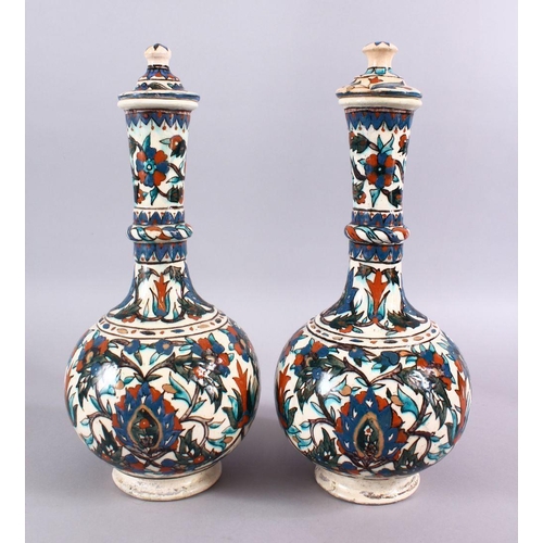 602 - A LARGE PAIR OF 19TH CENTURY OTTOMAN TURKISH KUTAHIYA LIDDED PORCELAIN BOTTLE VASES,each with floral... 