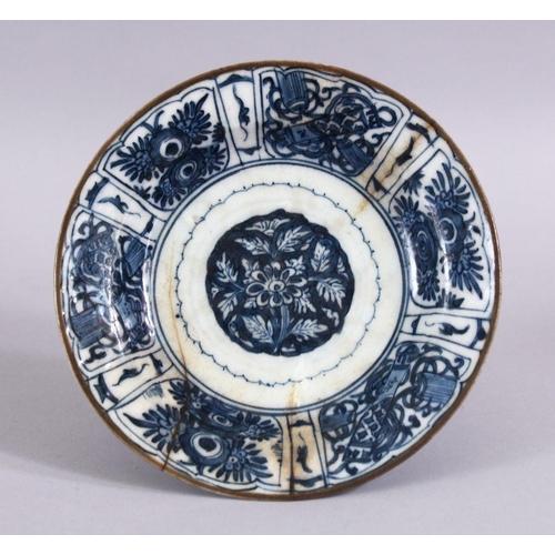 605 - A 17TH CENTURY PERSIAN SAFAVID BLUE AND WHITE DISH, decorated with precious objects and native flora... 