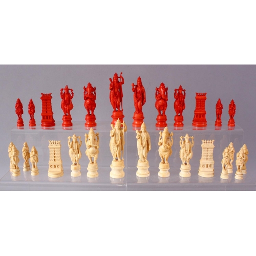 615 - AN EARLY 20TH CENTURY IVORY AND STAINED IVORY INDIAN CHESS SET, carved as Indian gods and temples, l... 