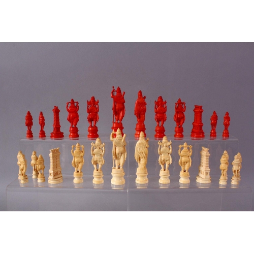 615 - AN EARLY 20TH CENTURY IVORY AND STAINED IVORY INDIAN CHESS SET, carved as Indian gods and temples, l... 