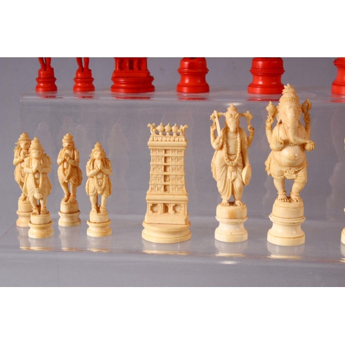 615 - AN EARLY 20TH CENTURY IVORY AND STAINED IVORY INDIAN CHESS SET, carved as Indian gods and temples, l... 