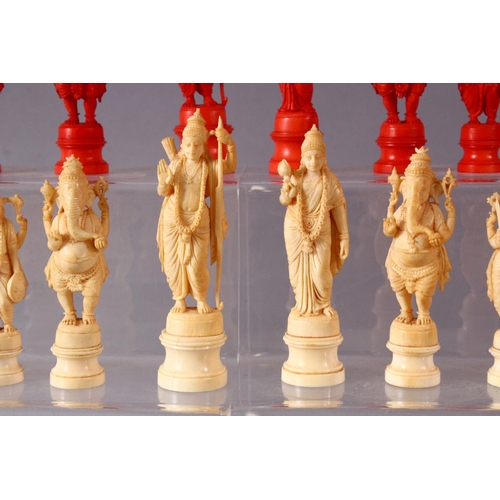 615 - AN EARLY 20TH CENTURY IVORY AND STAINED IVORY INDIAN CHESS SET, carved as Indian gods and temples, l... 