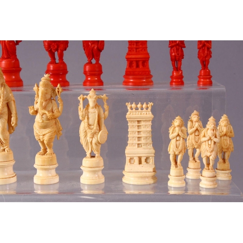 615 - AN EARLY 20TH CENTURY IVORY AND STAINED IVORY INDIAN CHESS SET, carved as Indian gods and temples, l... 