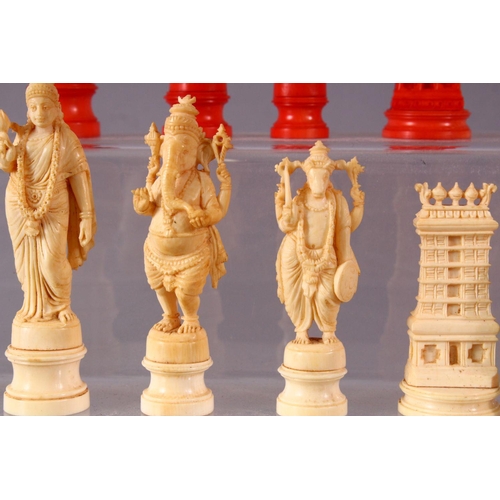 615 - AN EARLY 20TH CENTURY IVORY AND STAINED IVORY INDIAN CHESS SET, carved as Indian gods and temples, l... 