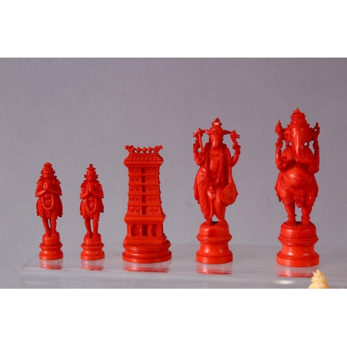 615 - AN EARLY 20TH CENTURY IVORY AND STAINED IVORY INDIAN CHESS SET, carved as Indian gods and temples, l... 