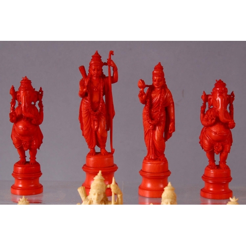 615 - AN EARLY 20TH CENTURY IVORY AND STAINED IVORY INDIAN CHESS SET, carved as Indian gods and temples, l... 