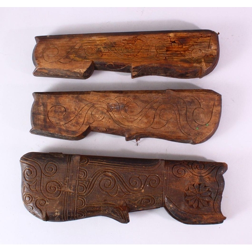 617 - THREE INDIAN CARVED WOODEN SPICE BOXES, largest 40cm long.