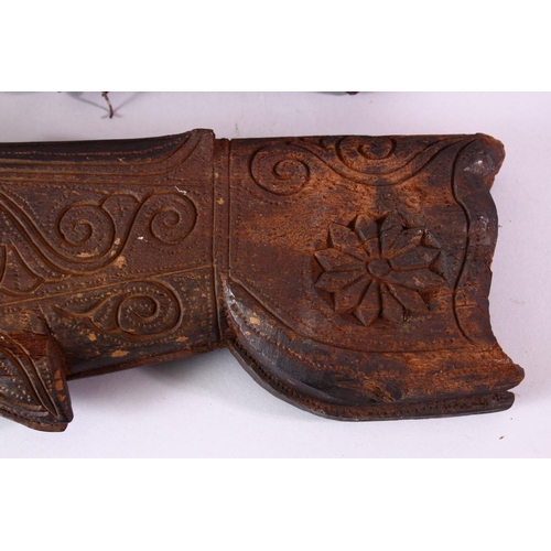 617 - THREE INDIAN CARVED WOODEN SPICE BOXES, largest 40cm long.