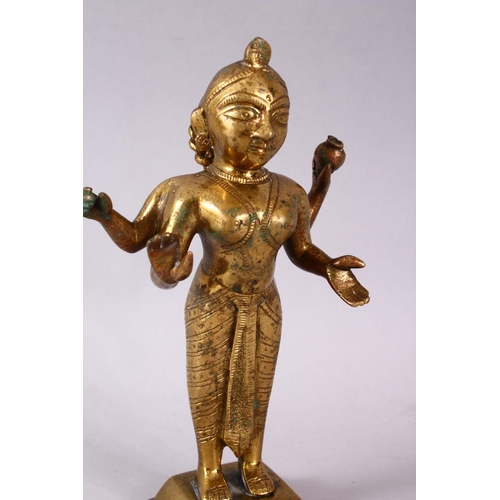 750 - A 19TH / 20TH CENTURY INDIAN BRONZE IGURE OF A DEITY, stood holding a vessel with plated hair, 20cm