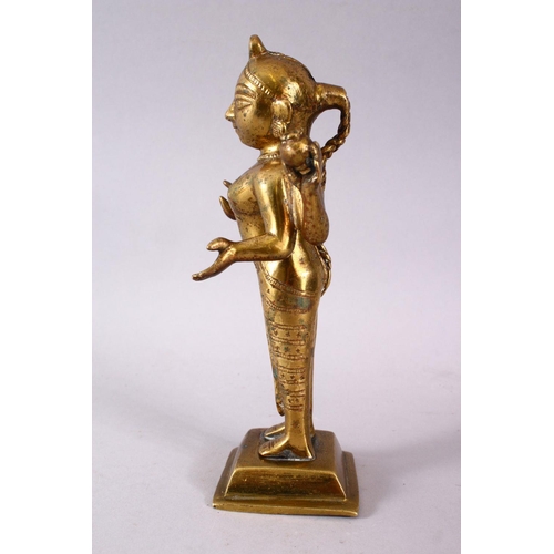 750 - A 19TH / 20TH CENTURY INDIAN BRONZE IGURE OF A DEITY, stood holding a vessel with plated hair, 20cm