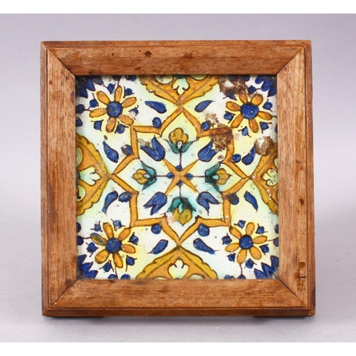 754 - A 19TH / 20TH CENTURY TURKISH POTTERY TILE SECTION, housed within a wooden frame with feet, decorate... 