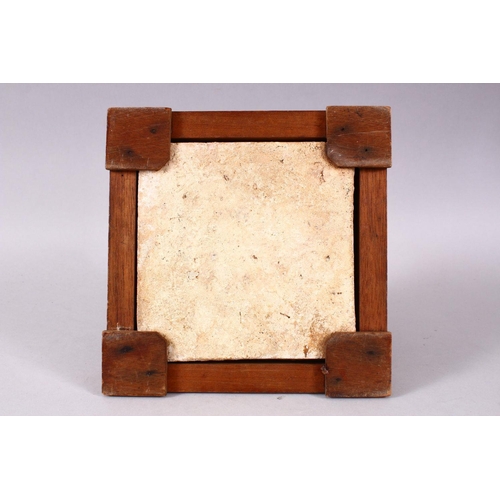 754 - A 19TH / 20TH CENTURY TURKISH POTTERY TILE SECTION, housed within a wooden frame with feet, decorate... 