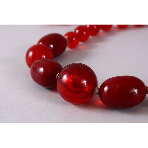 760 - A GOOD SET OF CHERRY AMBER ROSARY BEAD NECKLACE, with graduating bead size, approx open size 84cm.