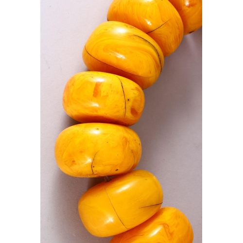 766 - A LARGE SET OF TURKISH? PRESSED AMBER BEAD NECKLACE, 20 beads, each bead approx. 5cm, overall approx... 