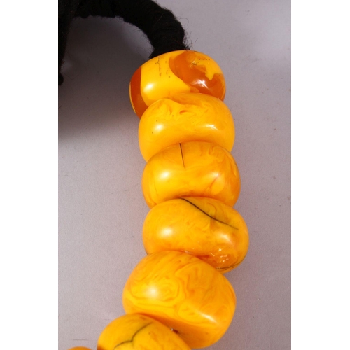 766 - A LARGE SET OF TURKISH? PRESSED AMBER BEAD NECKLACE, 20 beads, each bead approx. 5cm, overall approx... 