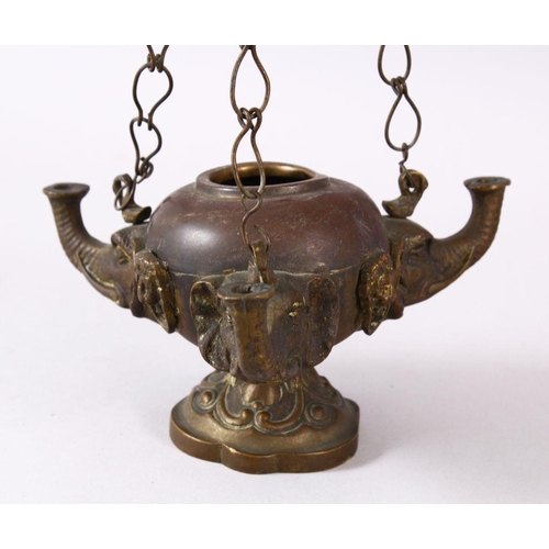 768 - AN INDIAN ELEPHANT FORMED BRONZE HANGING OIL LAMP, with three elephant heads and chains, 16cm wide.