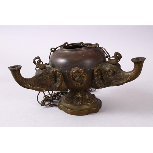 768 - AN INDIAN ELEPHANT FORMED BRONZE HANGING OIL LAMP, with three elephant heads and chains, 16cm wide.