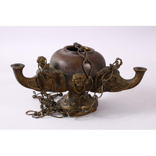 768 - AN INDIAN ELEPHANT FORMED BRONZE HANGING OIL LAMP, with three elephant heads and chains, 16cm wide.