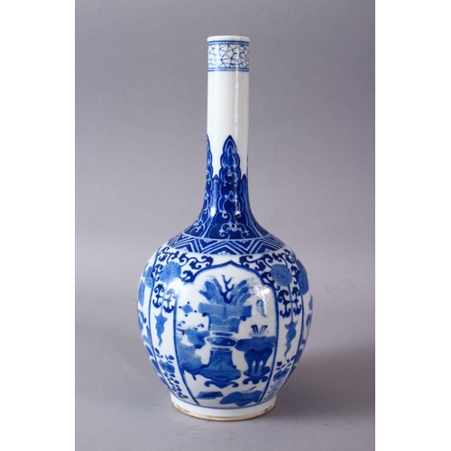 77 - A CHINESE KANGXI STYLE BLUE & WHITE PORCELAIN BOTTLE VASE, with panel decoration of lion dogs and fl... 