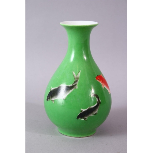 8 - A CHINESE GREEN GLAZED VASE, painted with fish, mark in red, 15cm high.