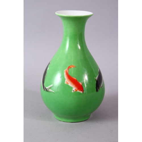 8 - A CHINESE GREEN GLAZED VASE, painted with fish, mark in red, 15cm high.