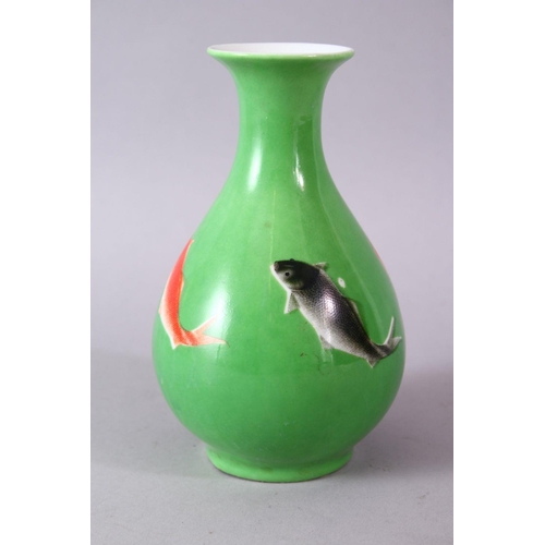 8 - A CHINESE GREEN GLAZED VASE, painted with fish, mark in red, 15cm high.