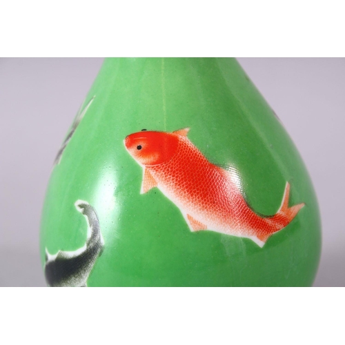 8 - A CHINESE GREEN GLAZED VASE, painted with fish, mark in red, 15cm high.