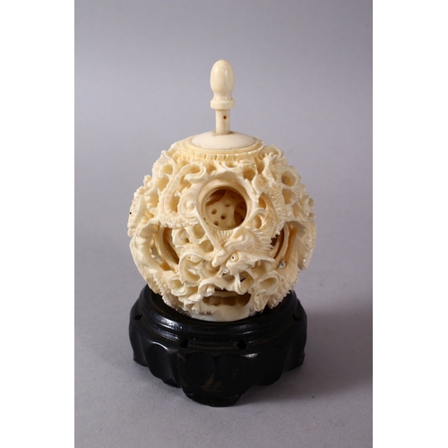 164C - A 19TH CENTURY CHINESE CANTON CARVED IVORY PUZZLE BALL, carved with scenes of a dragon with its fini... 