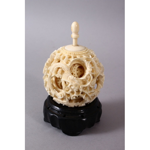 164C - A 19TH CENTURY CHINESE CANTON CARVED IVORY PUZZLE BALL, carved with scenes of a dragon with its fini... 