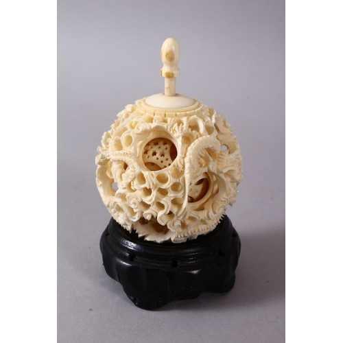 164C - A 19TH CENTURY CHINESE CANTON CARVED IVORY PUZZLE BALL, carved with scenes of a dragon with its fini... 