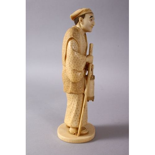 164E - A JAPANESE MEIJI PERIOD CARVED IVORY OKIMONO - MAN, stood in traditional dress, holding his staff an... 