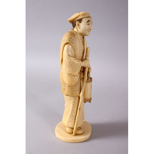 164E - A JAPANESE MEIJI PERIOD CARVED IVORY OKIMONO - MAN, stood in traditional dress, holding his staff an... 