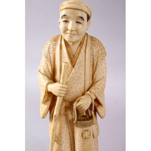 164E - A JAPANESE MEIJI PERIOD CARVED IVORY OKIMONO - MAN, stood in traditional dress, holding his staff an... 