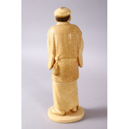 164E - A JAPANESE MEIJI PERIOD CARVED IVORY OKIMONO - MAN, stood in traditional dress, holding his staff an... 