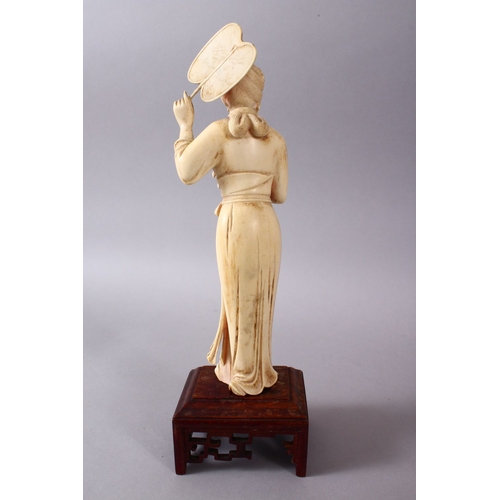 164G - A JAPANESE MEIJI PERIOD CARVED IVORY OKIMONO OF A GEISHA GIRL & FAN, stood holding an uchiwa fan alo... 