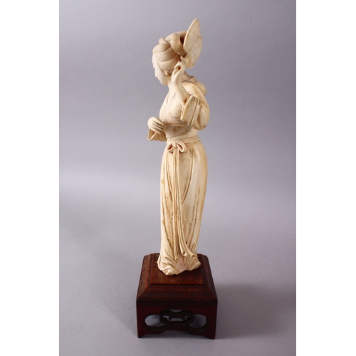 164G - A JAPANESE MEIJI PERIOD CARVED IVORY OKIMONO OF A GEISHA GIRL & FAN, stood holding an uchiwa fan alo... 