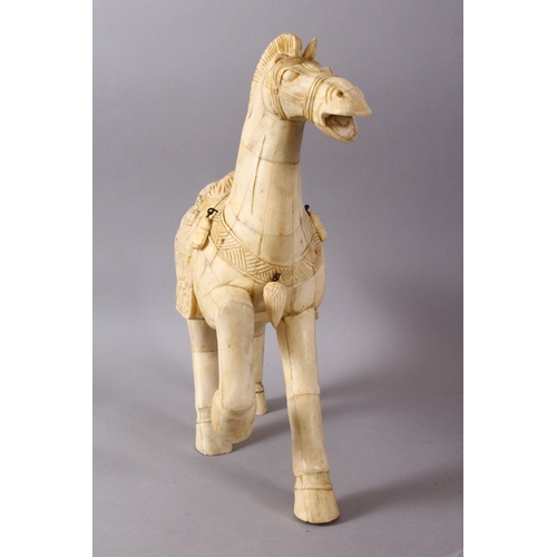 164I - A LARGE 19TH / 20TH CENTURY CHINESE CARVED SECTIONAL BONE FIGURE OF A TANG STYLE HORSE, stood in a s... 