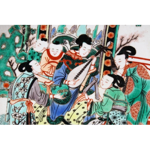 104 - A 20TH CENTURY CHINESE FAMILLE VERTE PORCELAIN DISH, painted with figures playing musical instrument... 