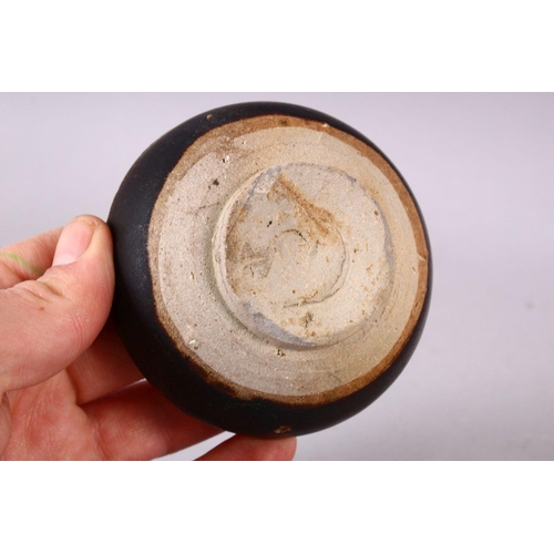 106 - A SMALL CHINESE TREACLE GLAZED CIRCULAR POTTERY BOX AND COVER, the cover with moulded dragon decorat... 