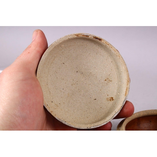 106 - A SMALL CHINESE TREACLE GLAZED CIRCULAR POTTERY BOX AND COVER, the cover with moulded dragon decorat... 
