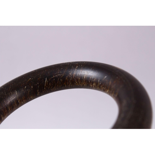 111 - TWO CHINESE HORN STYLE BANGLES, 9cm diameter.