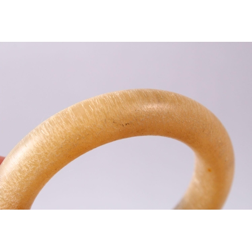 111 - TWO CHINESE HORN STYLE BANGLES, 9cm diameter.