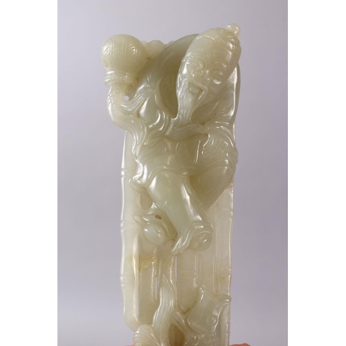 71 - A CHINESE CARVED CELADON JADE FIGURE OF A RECLINED IMMORTAL & FISH, the immortal figure reclined upo... 